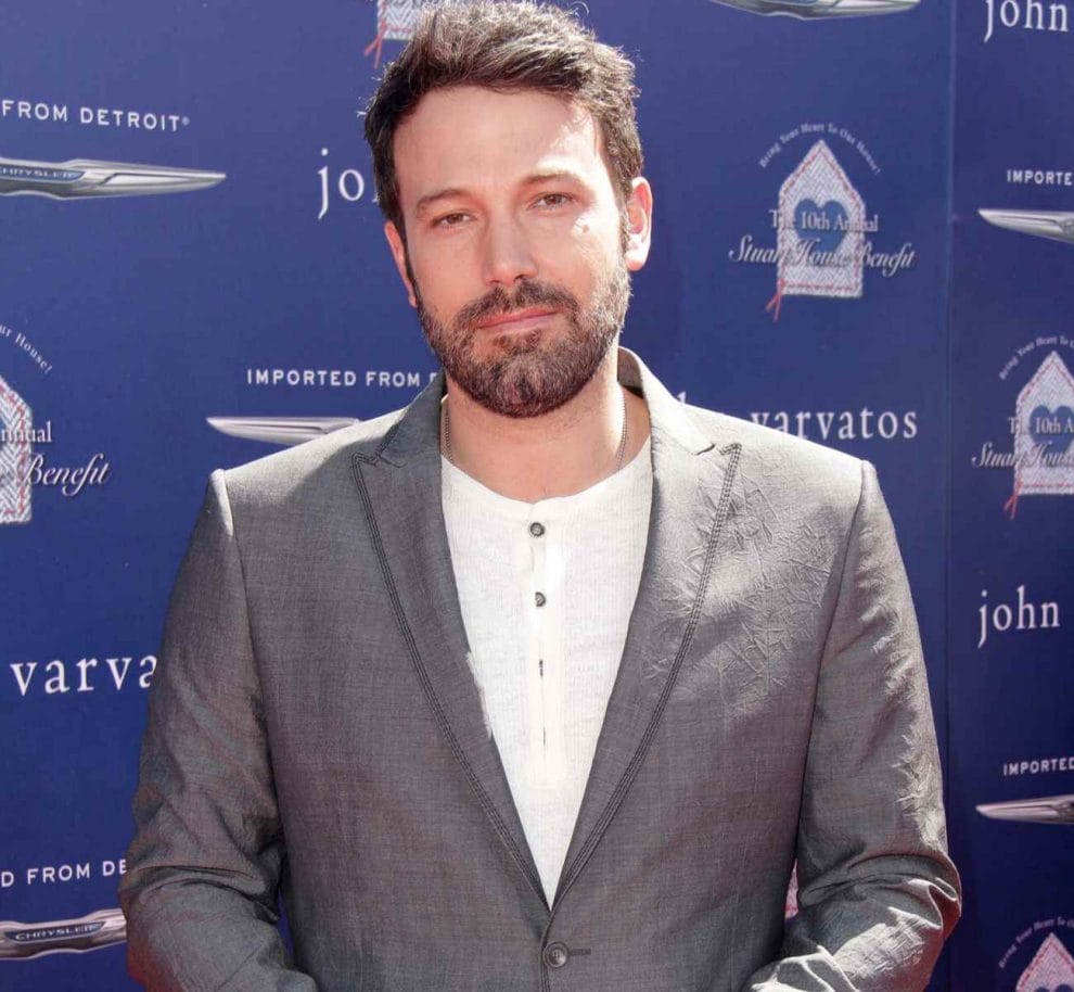 Ben Affleck wearing a grey blazer and white top.