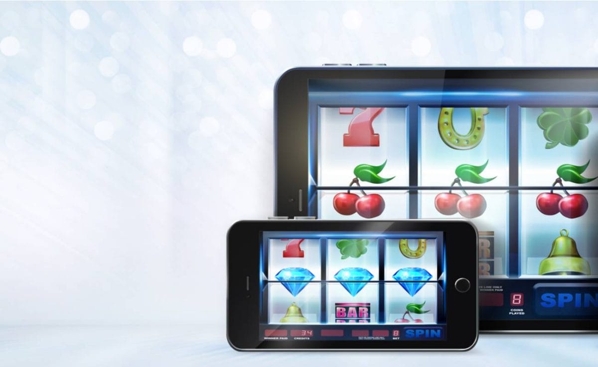 Tablet and iPhone displaying online slots game.
