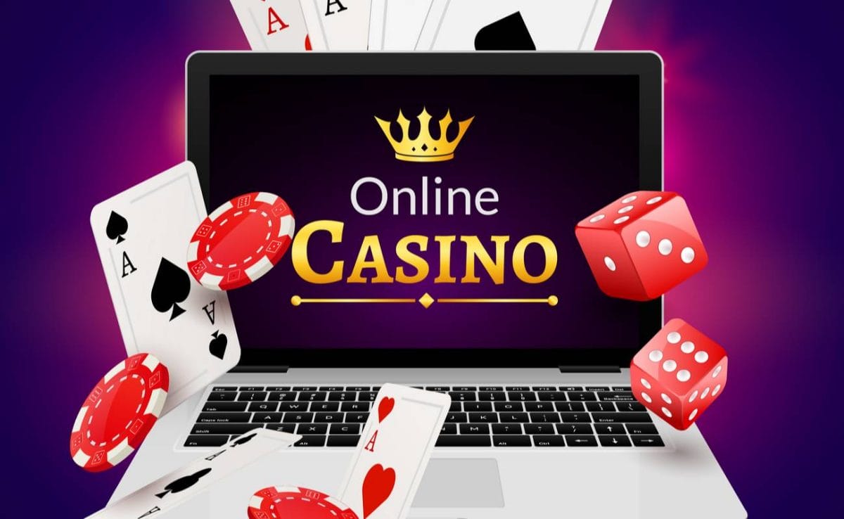 Laptop screen displaying online casino with cards, red dice and poker chips 