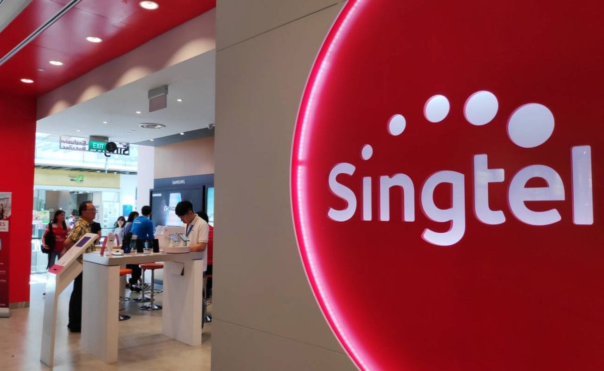 Singtel retail shop in Singapore, big red and white company logo. 