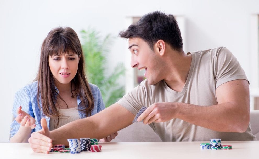 A woman and a man playing poker at home