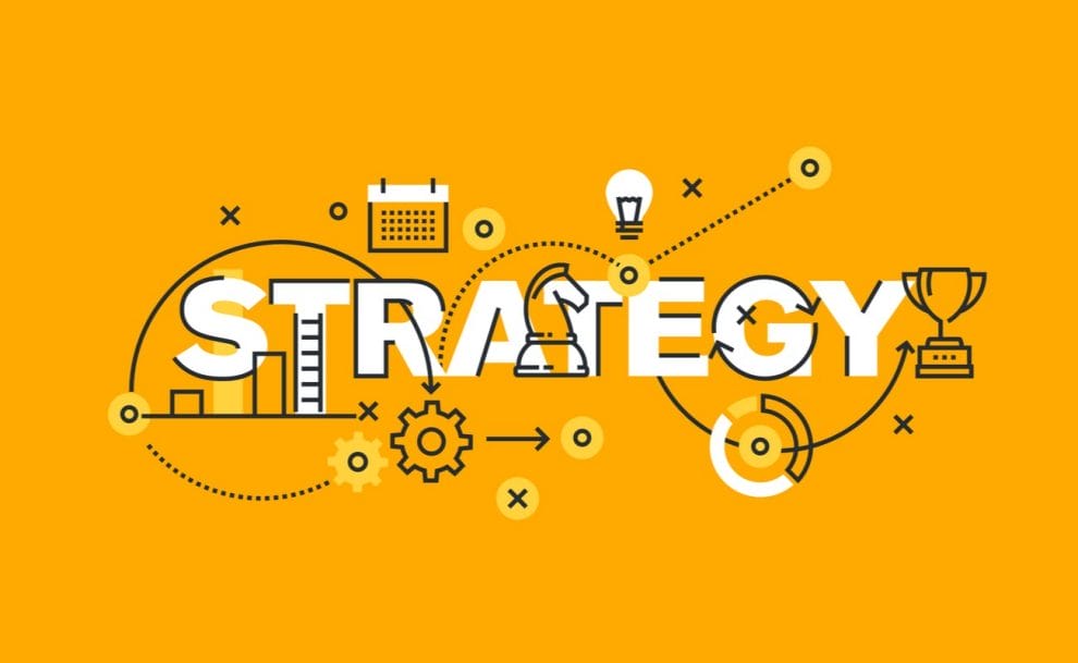 The word strategy written in a concept with cogs and other strategic items