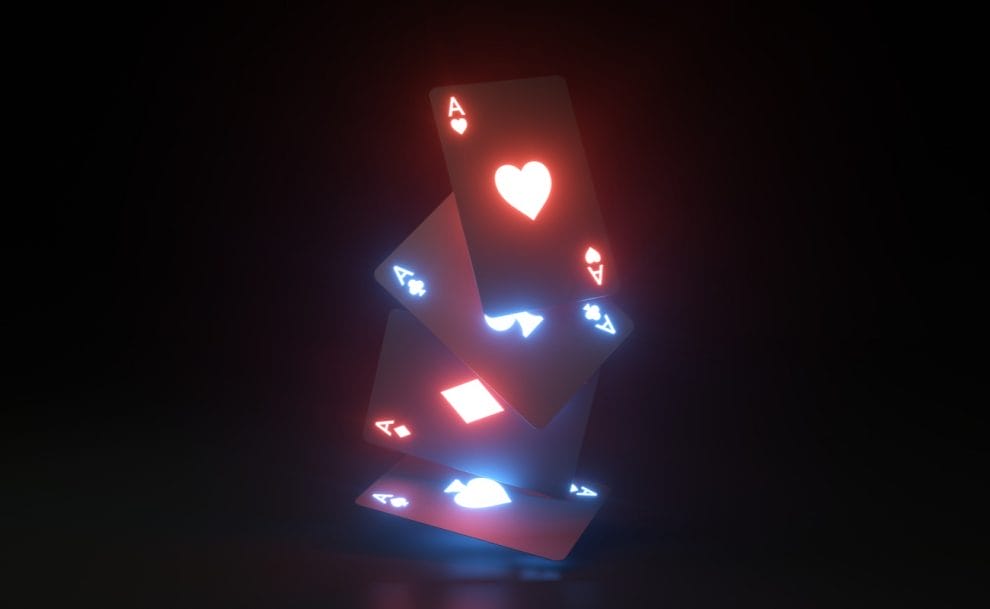 glowing playing cards falling against black background