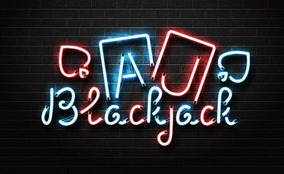 the word blackjack and two playing cards written in neon as a wall sign