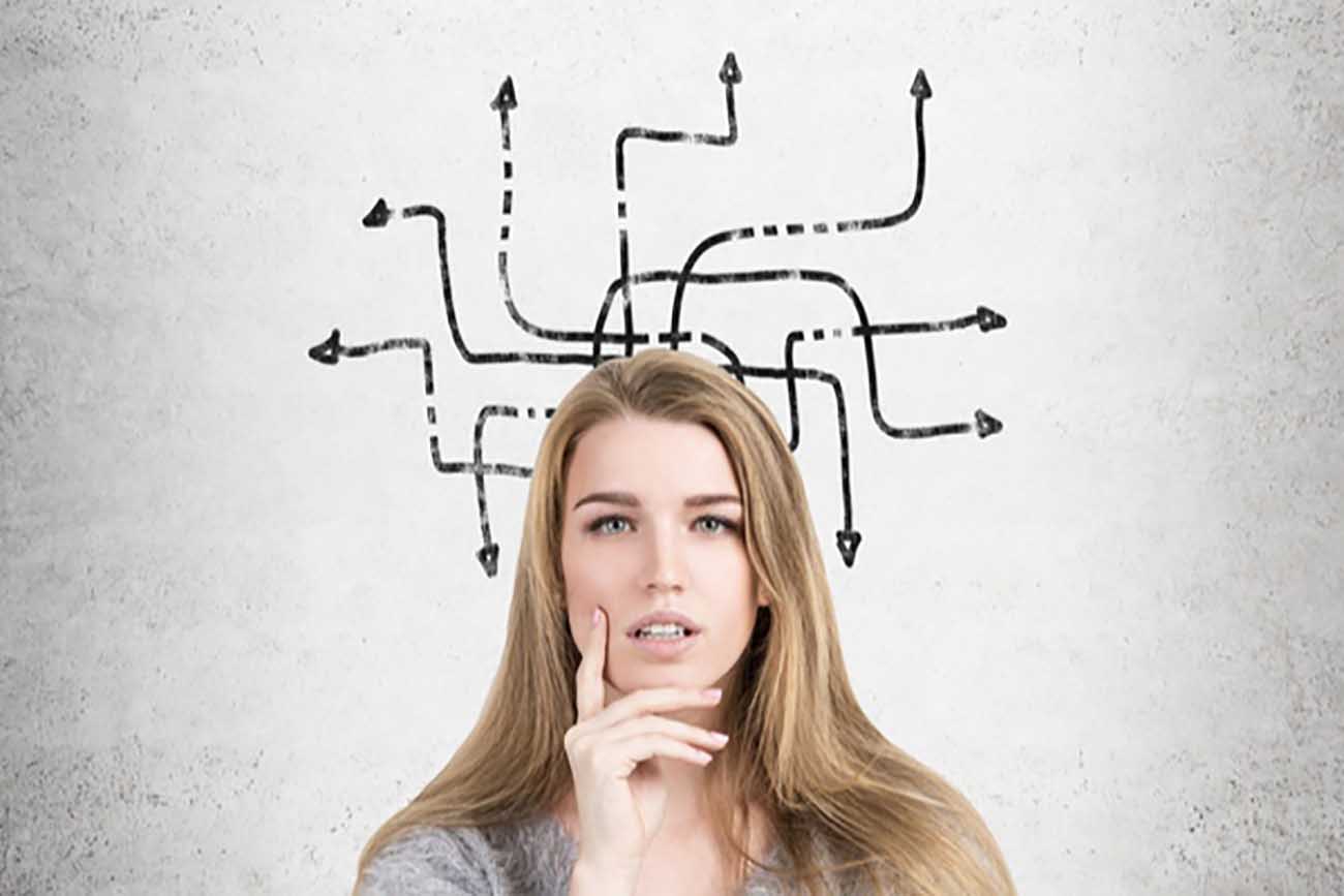 Girl staring with her hand on her chin thinking in front of a drawing