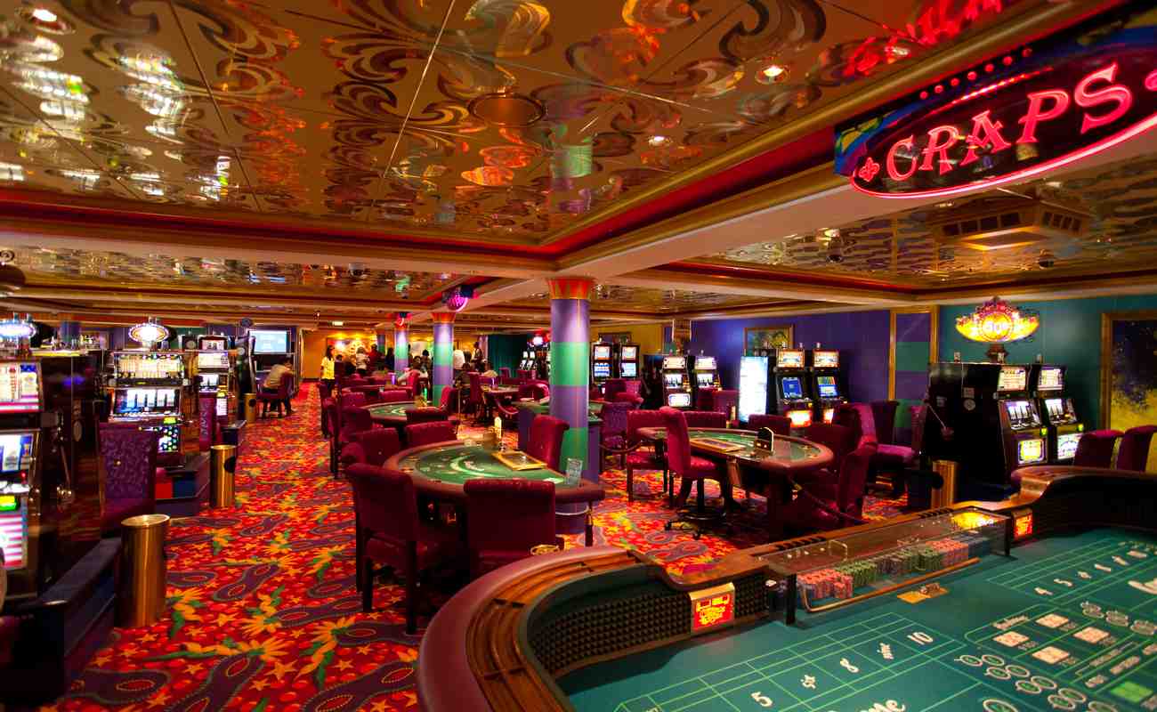 nside a casino with slot machines and poker tables