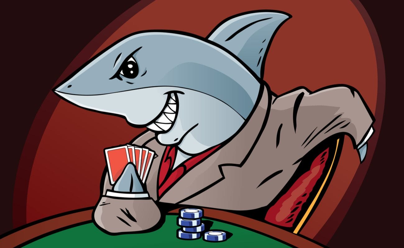 Cartoon shark in a suit holding playing cards and poker chips