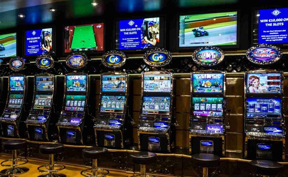 Seven video powered slot machines lined up in a casino
