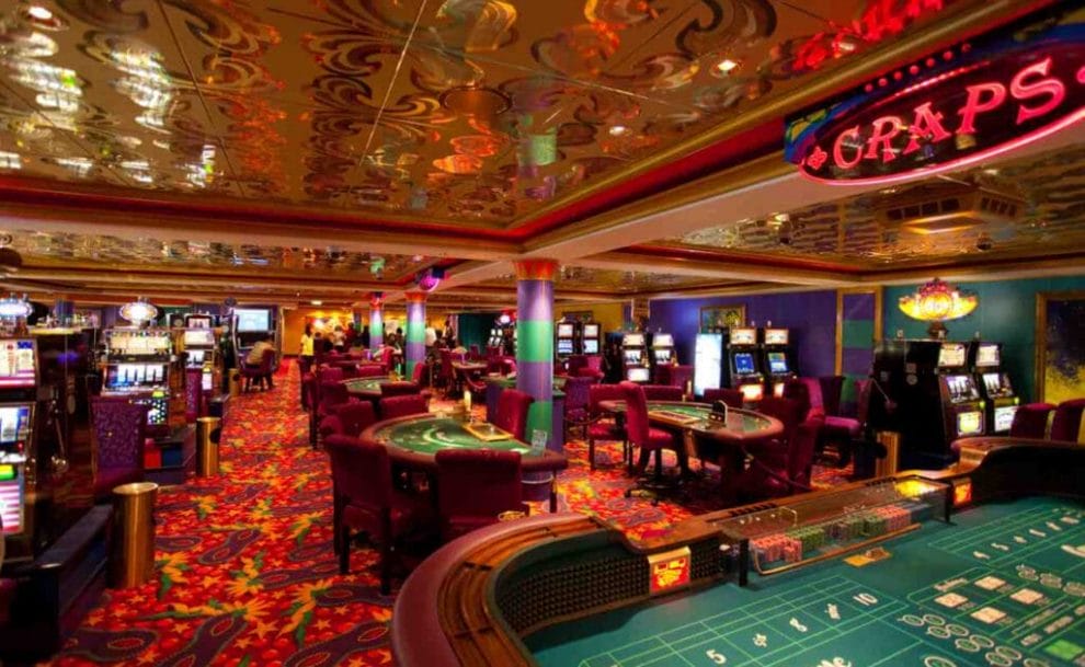 Inside a casino with slot machines and poker tables.