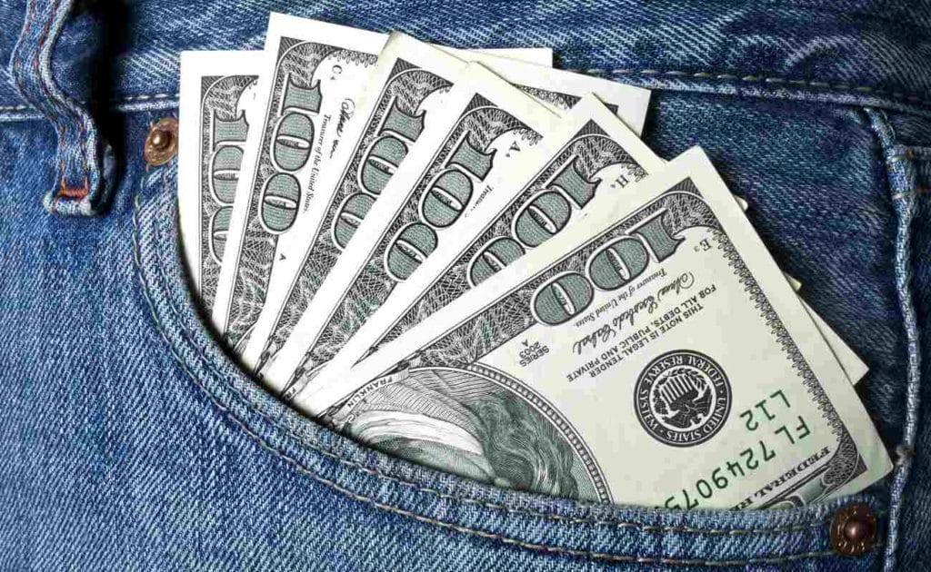 Dollars in pocket of blue jeans