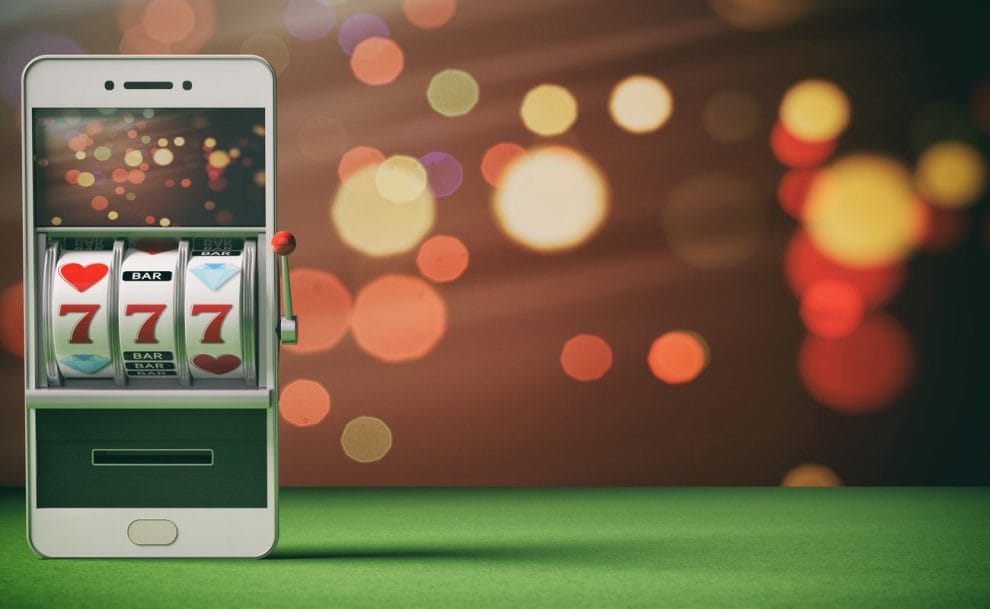 Slot machine on a smartphone screen, green felt and abstract background