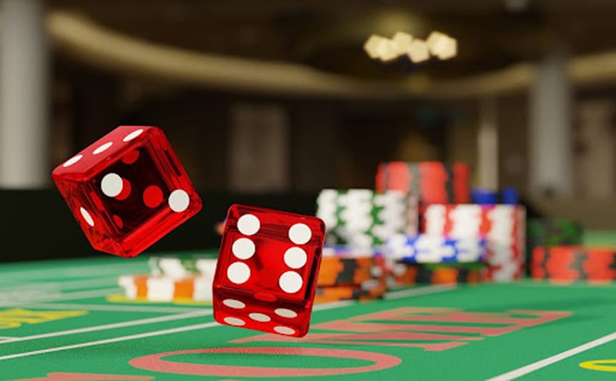 Red and white dice thrown across a craps table with casino chips in the background.