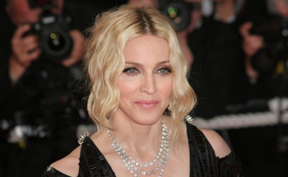 Singer Madonna attends the 'I Am Because We Are' premiere at the Palais Des Festivals wearing a black dress and diamond necklace