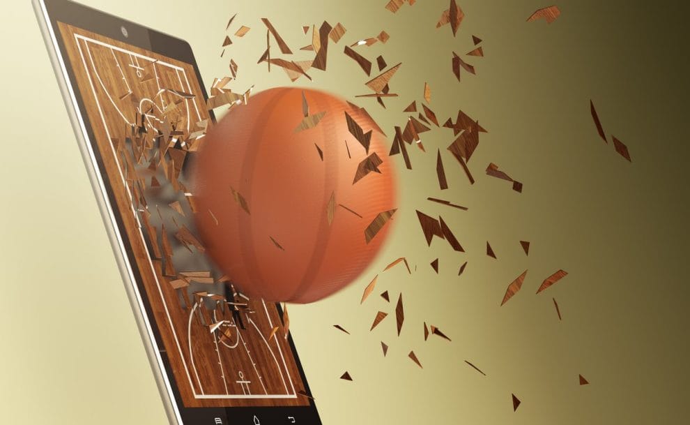 Basketball blasting out of table screen online basketball concept