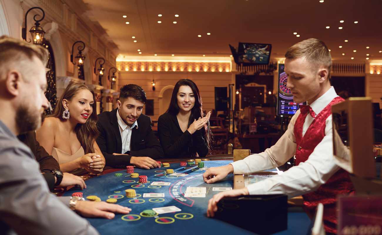  Croupier dealing cards to players in a casino.