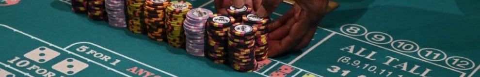 A craps dealer prepares stacks of casino chips