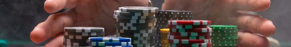  Close up of hands holding stacks of gambling chips