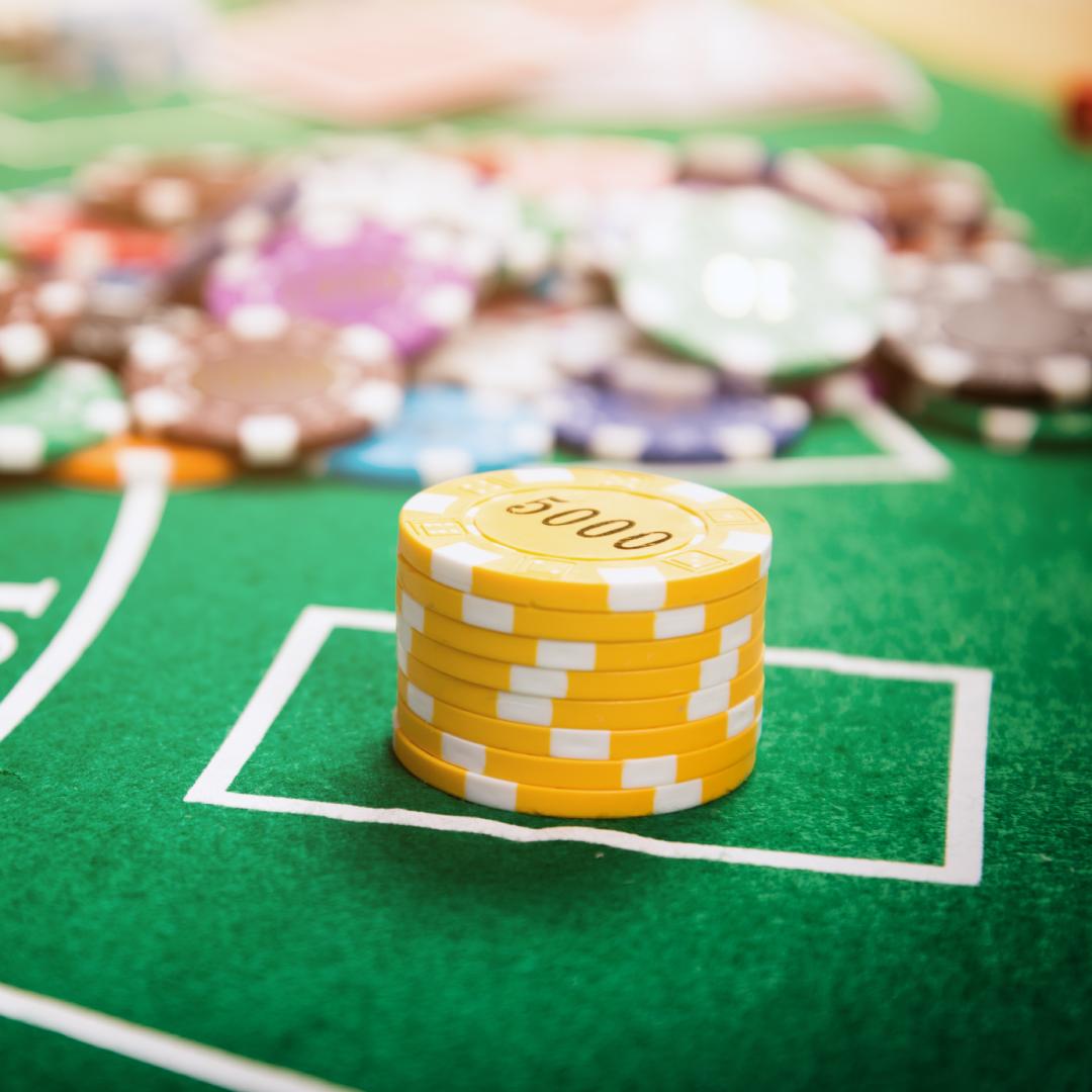Yellow casino chips on a green felt table.