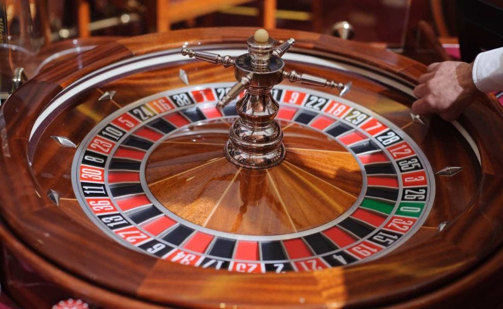 A croupier holds the ball before the Roulette wheel is spun.
