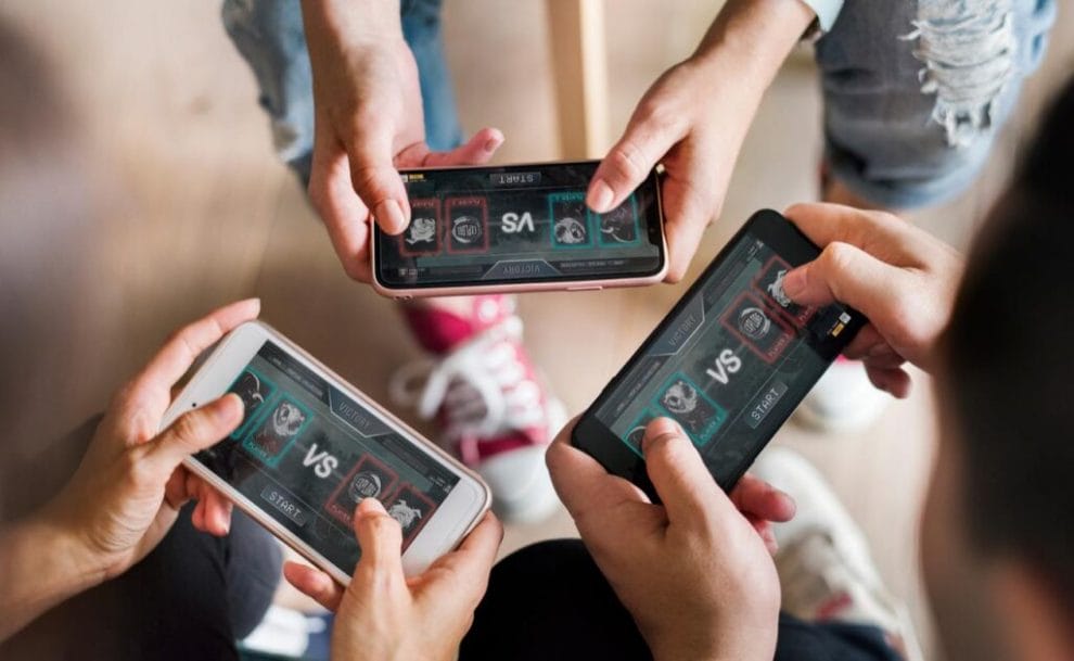 Aerial view of a group of friends playing a game on mobile phone