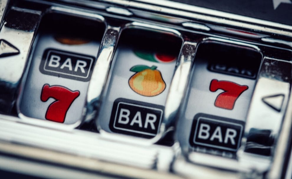 Closeup view of a casino slot machine’s reels and symbols.