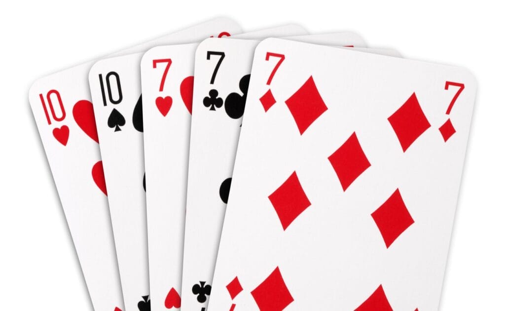 A full-house poker hand, consisting of two 10s and three sevens.