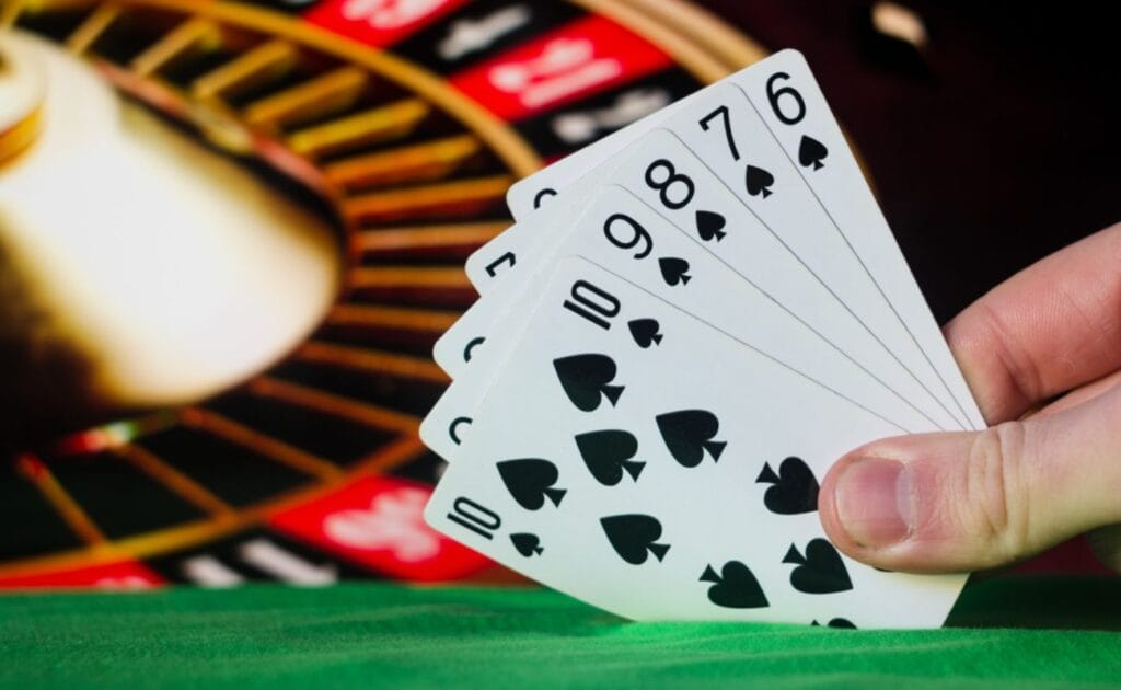 A player shows their straight-flush poker hand, starting from the six of spades and ending on the 10.