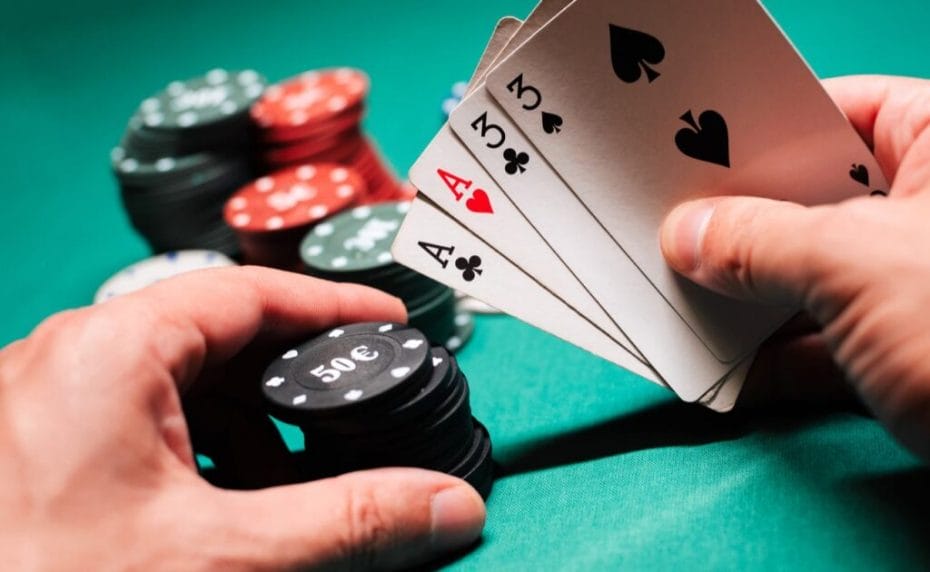 A player holds a pair of aces and threes in a regular game of poker.