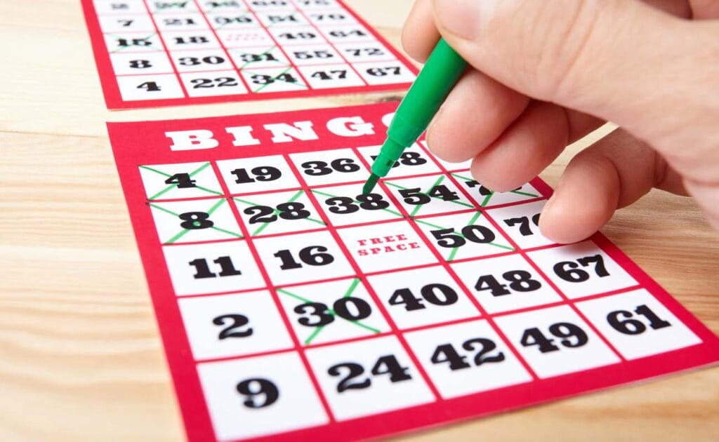 A bingo player marks off numbers on a bingo card.