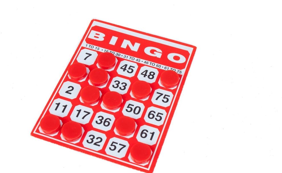 A red bingo card with red markers on some numbers.
