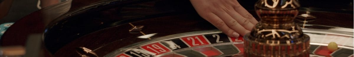 A woman’s hand on a roulette table.