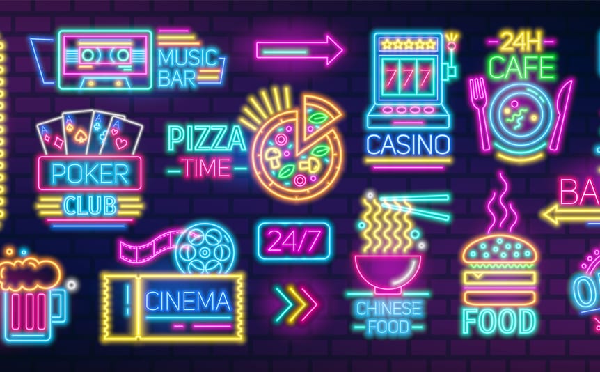 Neon colored signs and billboards containing food and casino symbols.