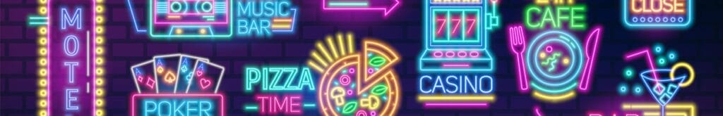 Neon colored signs and billboards containing food and casino symbols.