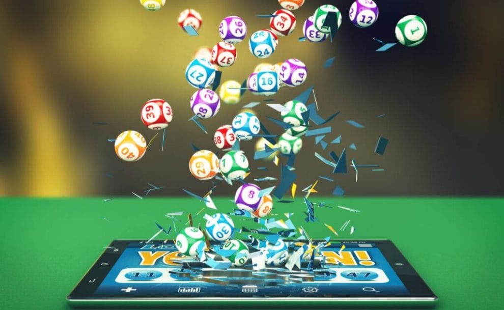 A digital render of bingo balls exploding out of a tablet screen.
