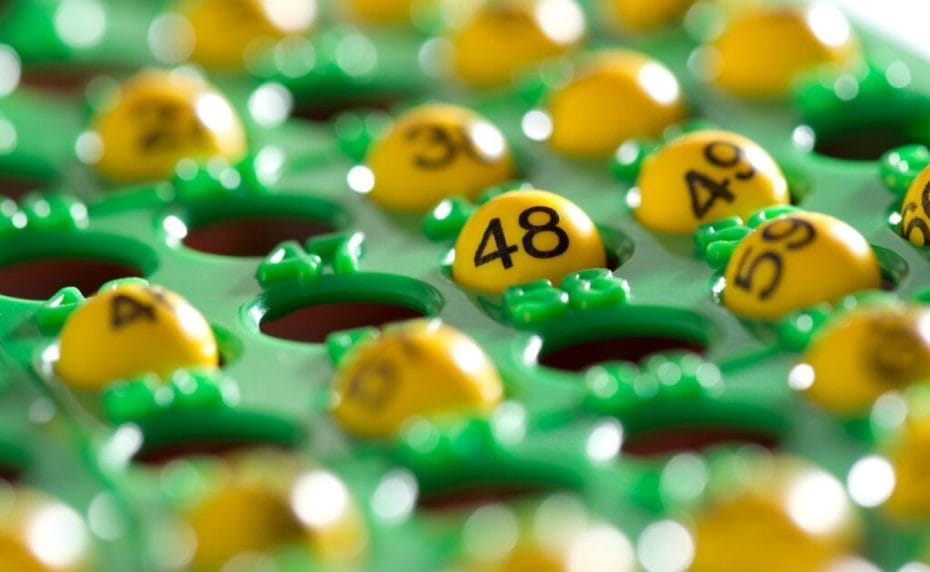 Colorful bingo board filled with yellow bingo balls displaying numbers.