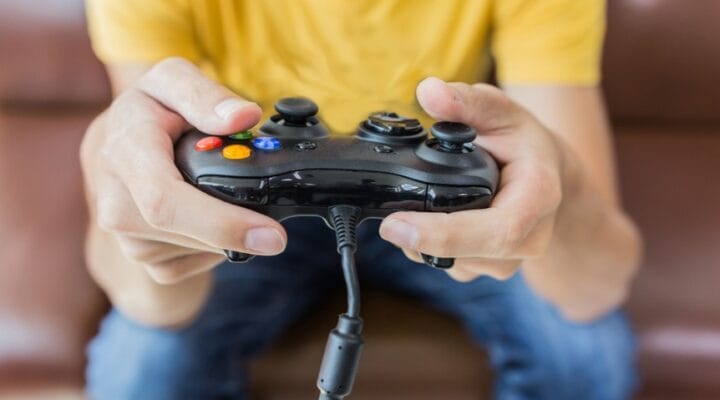 A person holds a video game controller.