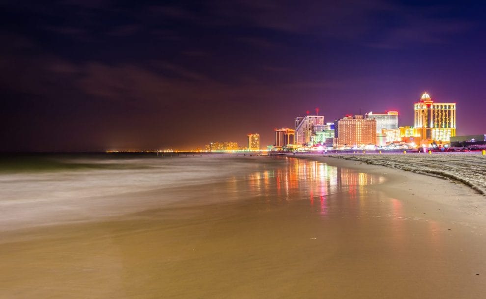 The beach and the nighttime skyline of Atlantic City in New Jersey.