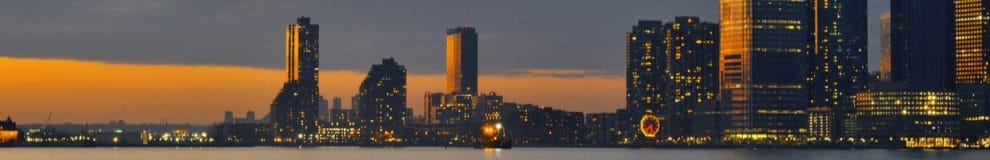 Header image of the evening skyline of Jersey City.