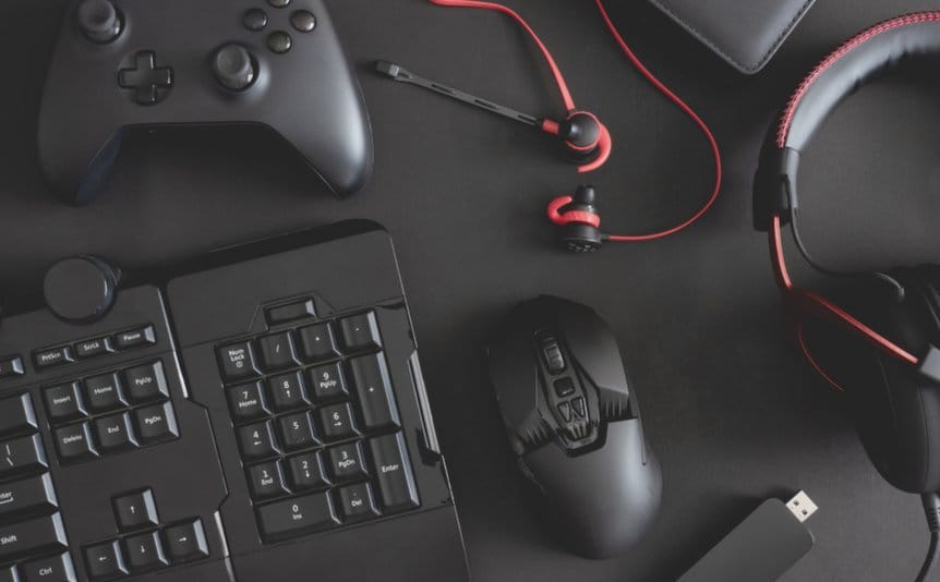 Various pieces of gaming technology, including a keyboard, mouse, and set of headphones.