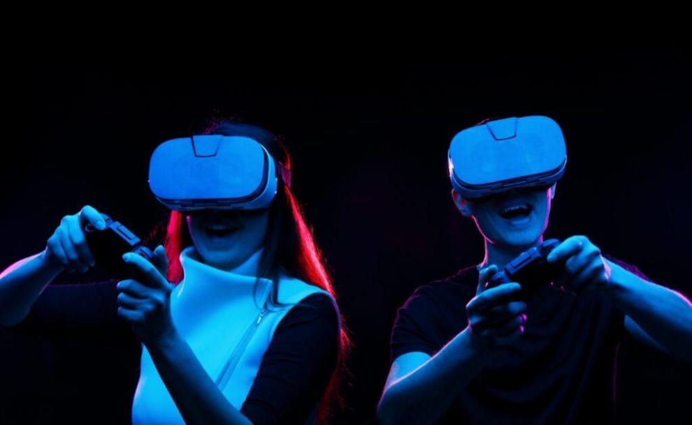 A couple play online games while wearing VR headsets.