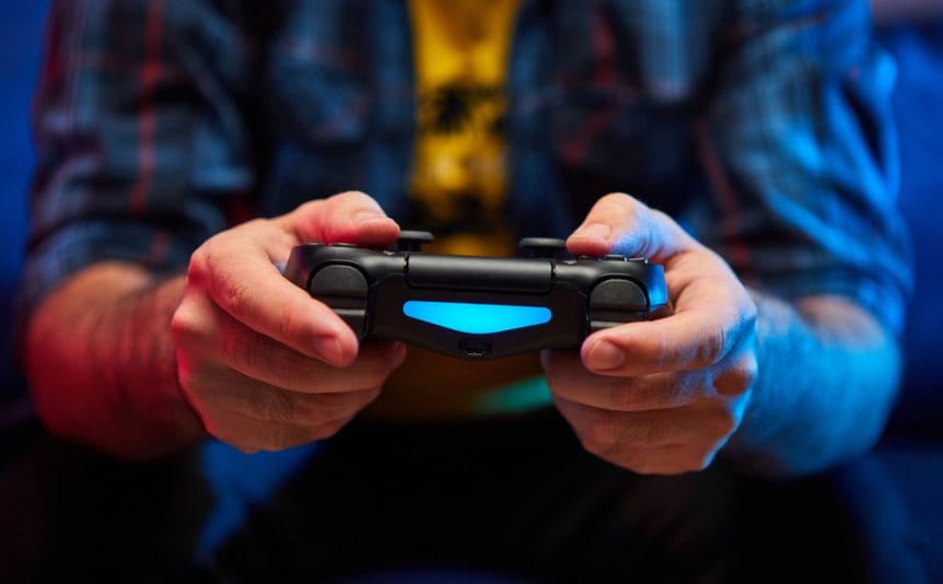 A man holds a video game controller.