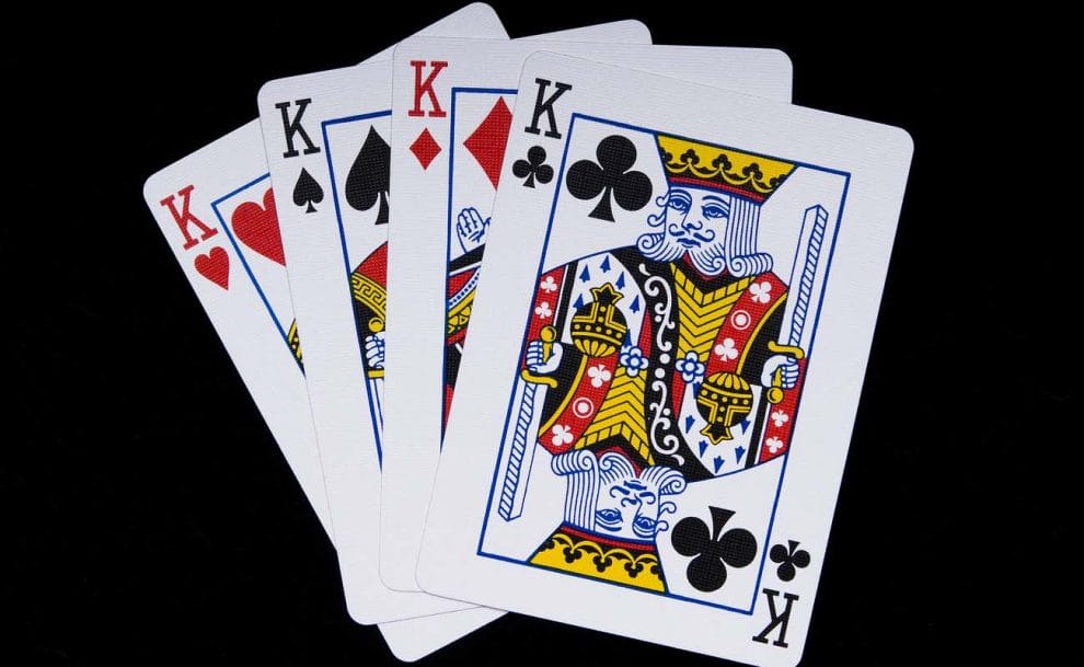 The king playing cards of all four suits, featured on a black background.