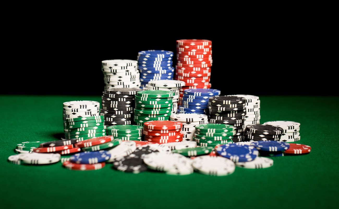 Close-up of casino chip stacks on a green table.