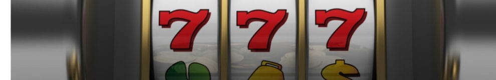Numbers 777 showing on casino slot machine reel.