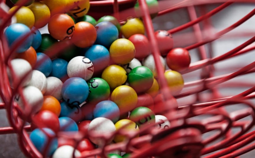 A bingo cage filled with bingo balls.