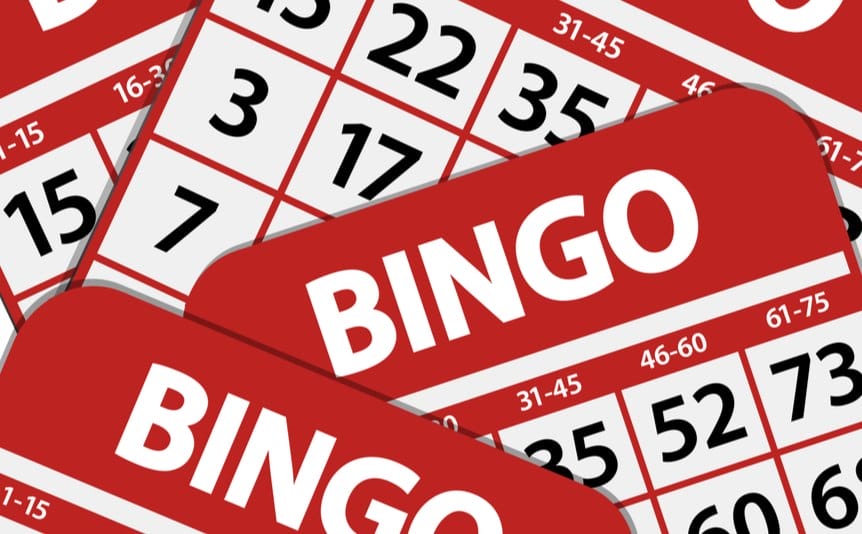 A few red bingo cards are stacked on top of each other.