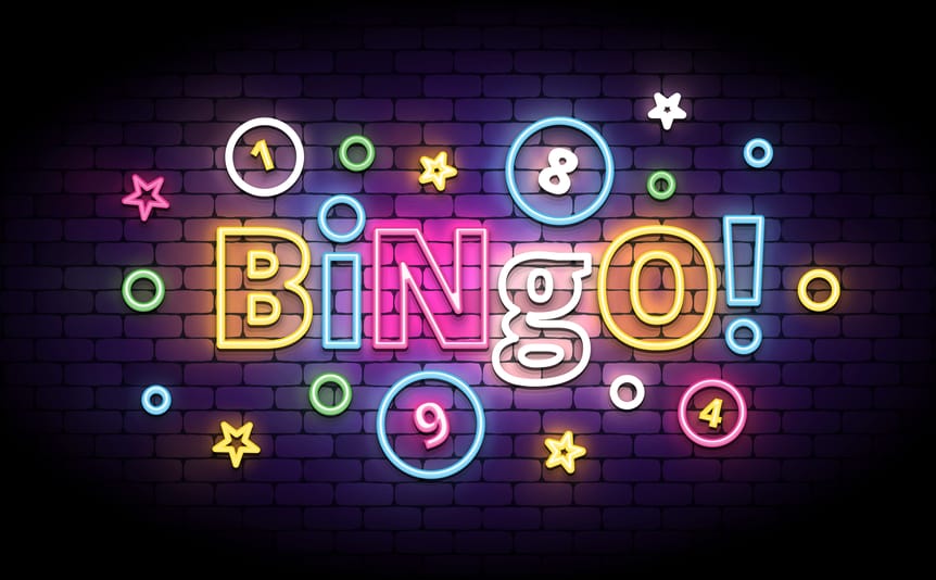 The world ‘bingo!’ spelled out in lights against a brick wall.