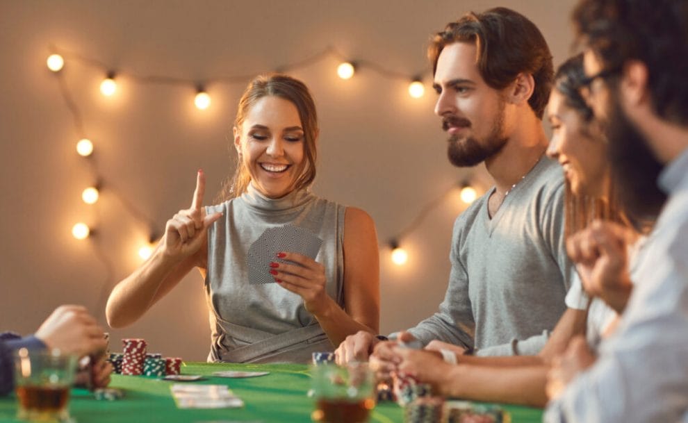 Friends playing casino table games at a casino theme party.