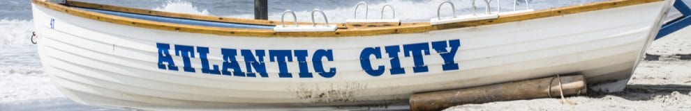 White lifeguard boat with Atlantic City on the side in blue.