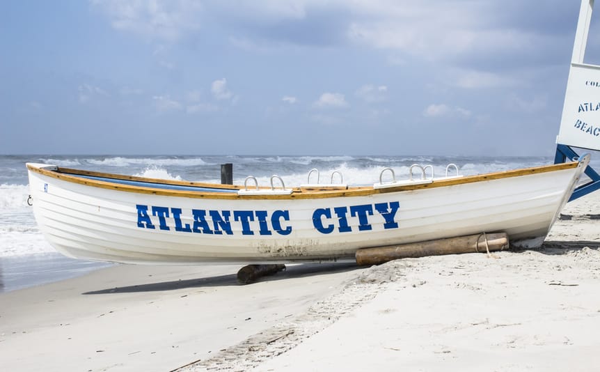 White lifeguard boat with Atlantic City on the side in blue.